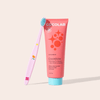 Cocoshine toothpaste tube with a pink toothbrush on a light beige background