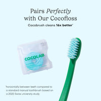 Green toothbrush with Cocolab packaging on a light blue background