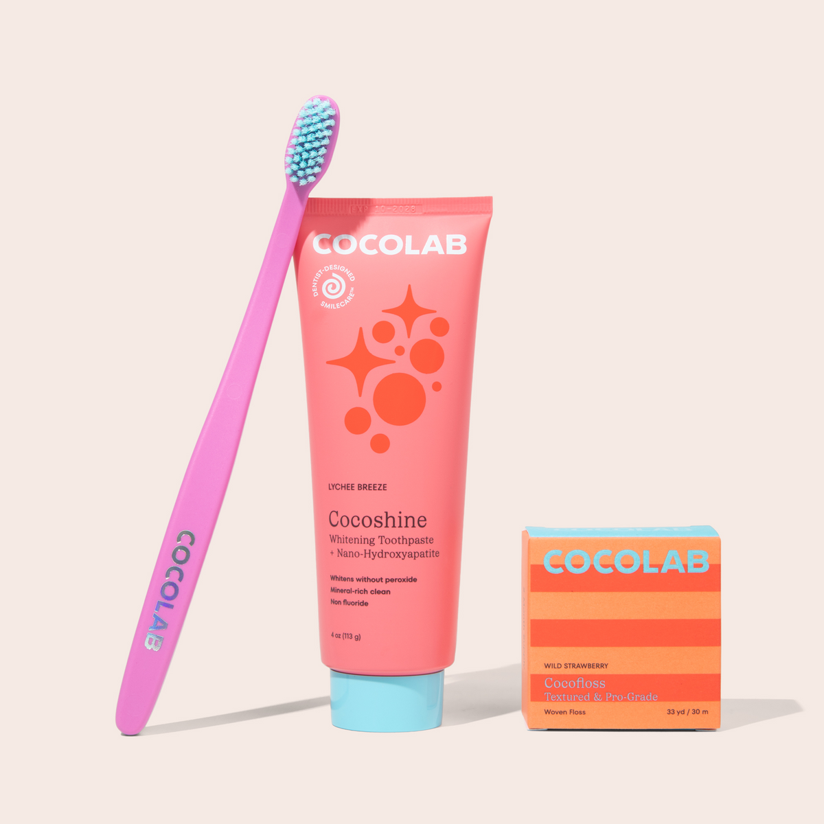 Cocolab toothpaste tube and brush with packaging on a light background