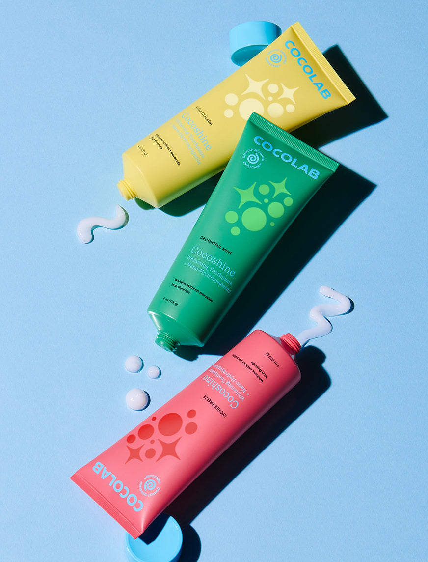 Three Cocoshine tubes on a blue background.