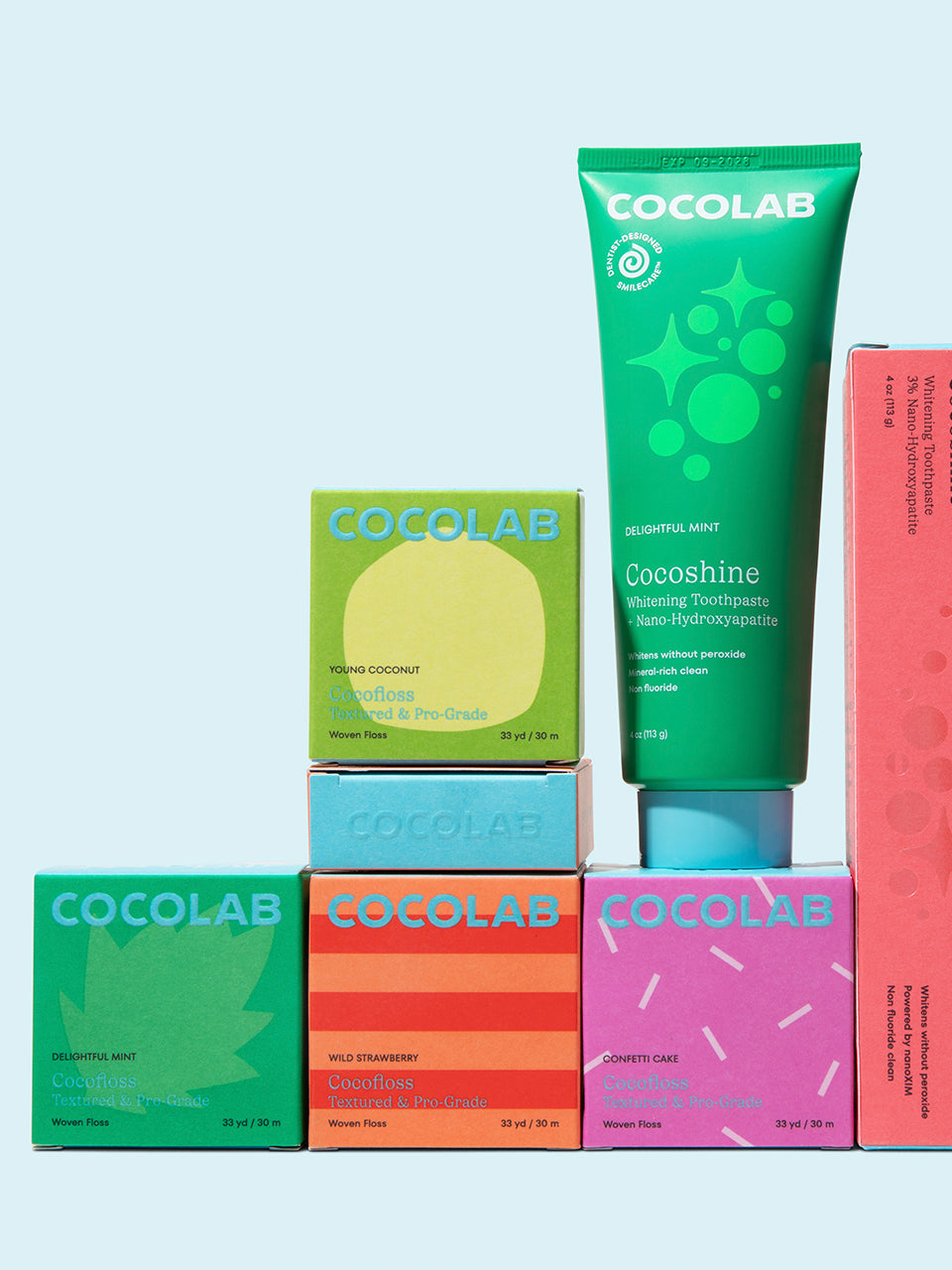 Cocolab dnetal products including bars and a tube on a light blue background