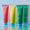 Colorful Cocolab Cocoshine on a reflective surface with a striped background