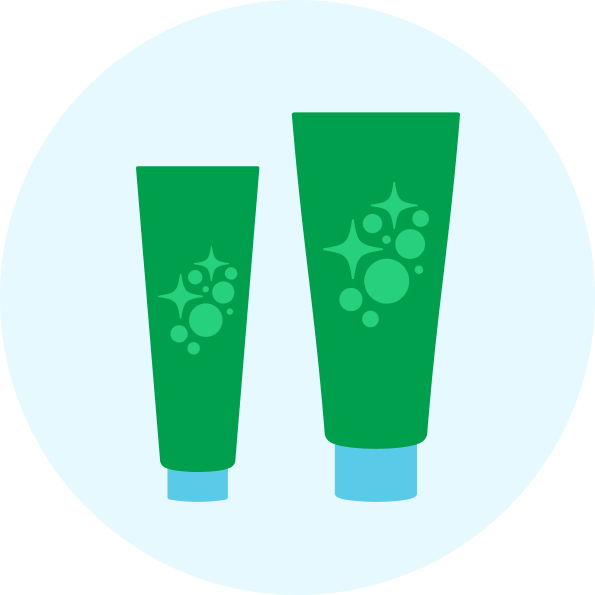 Two green tubes with blue caps on a light blue background