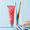 Cocolab toothpaste tube with two toothbrushes in a glass on a tiled bathroom shelf.